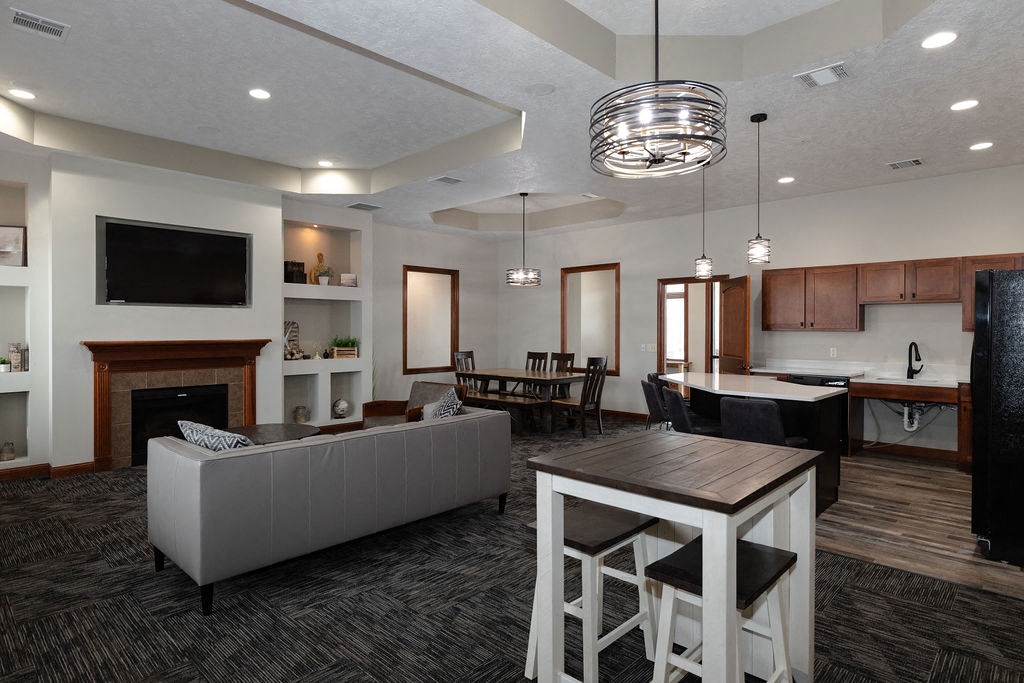 a living room and kitchen with a table and chairs