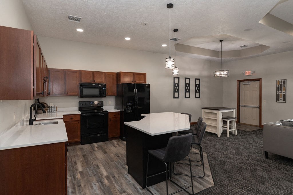 a kitchen and living room with a table and chairs