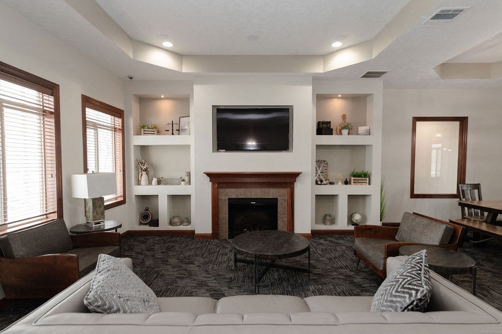 a living room with a white couch and a fireplace