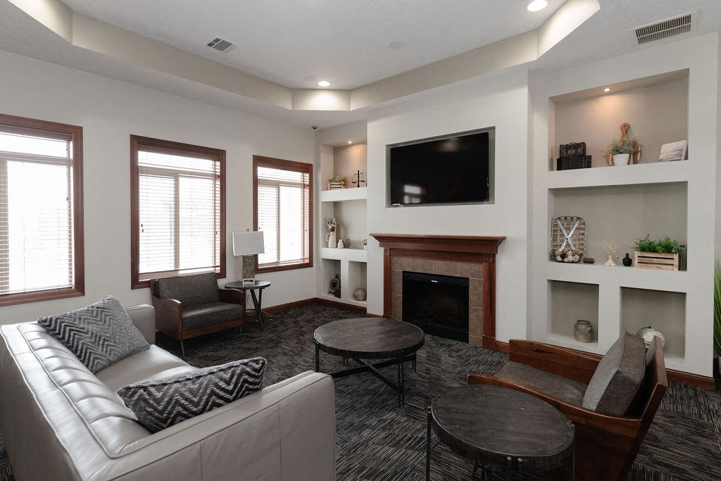 a living room with a white couch and a fireplace