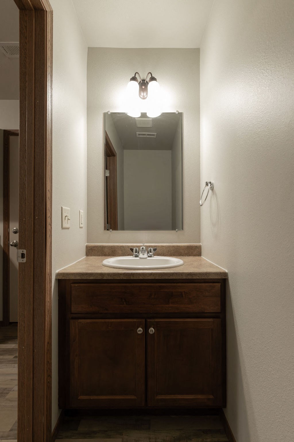 the ensuite bathroom has a sink and a mirror