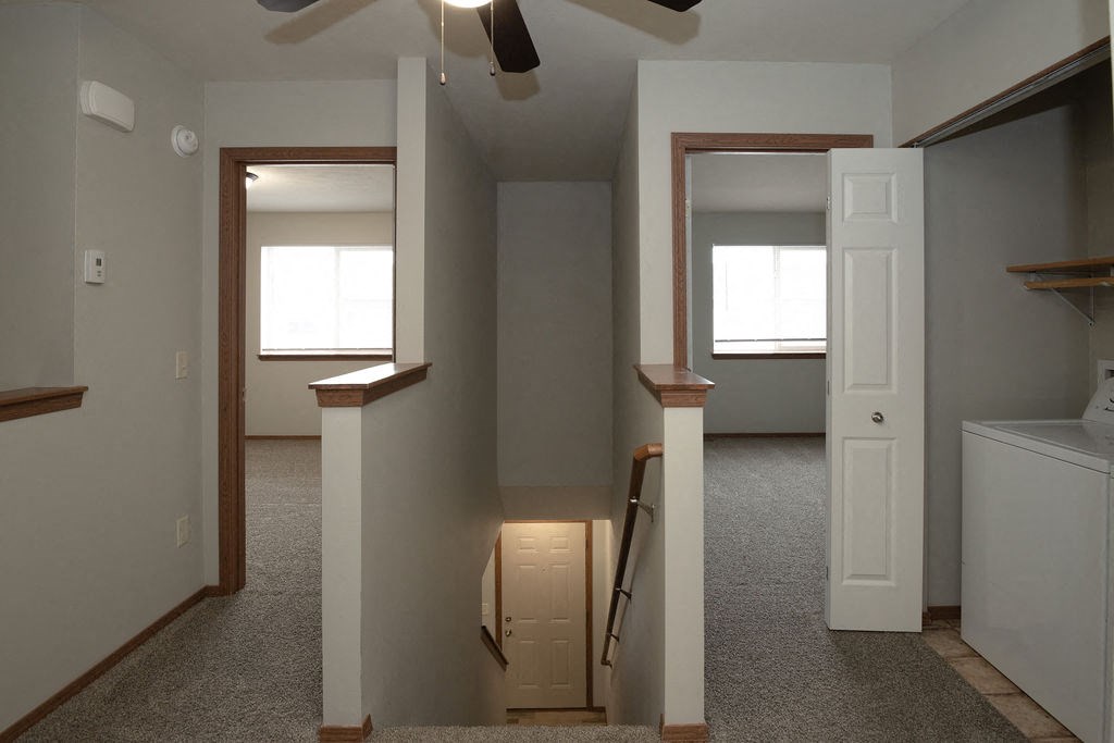 an empty room with a staircase in a house