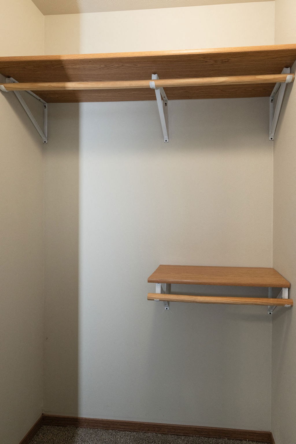 a bench in a room with a white wall