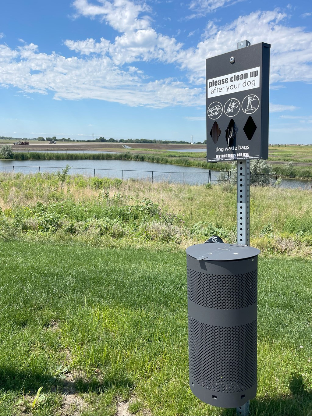 A sign asking to clean up after your dog is posted on a pole.