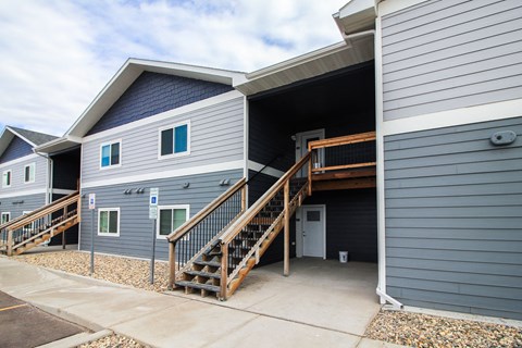A grey building with a blue sky in the background.