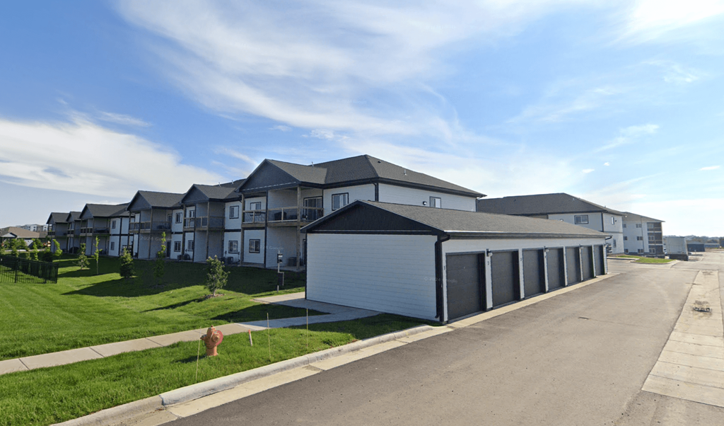 A row of houses with a garage in the foreground.