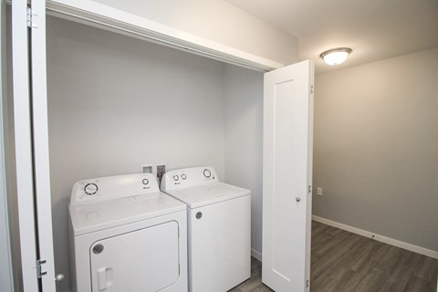 A laundry room with two washing machines.