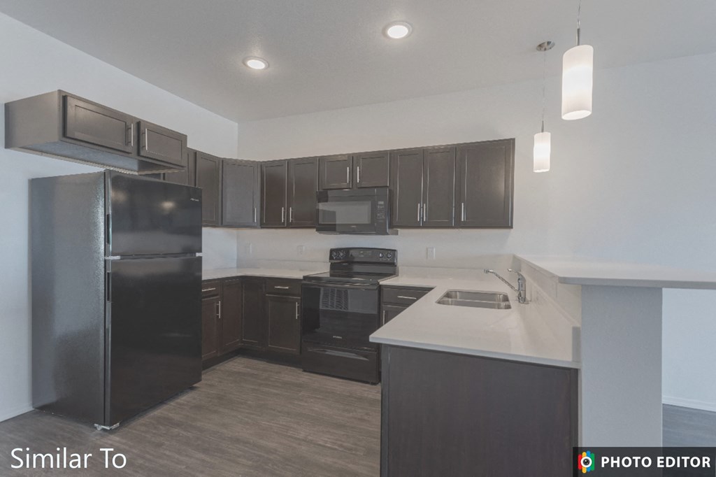a kitchen with black appliances and white counter tops