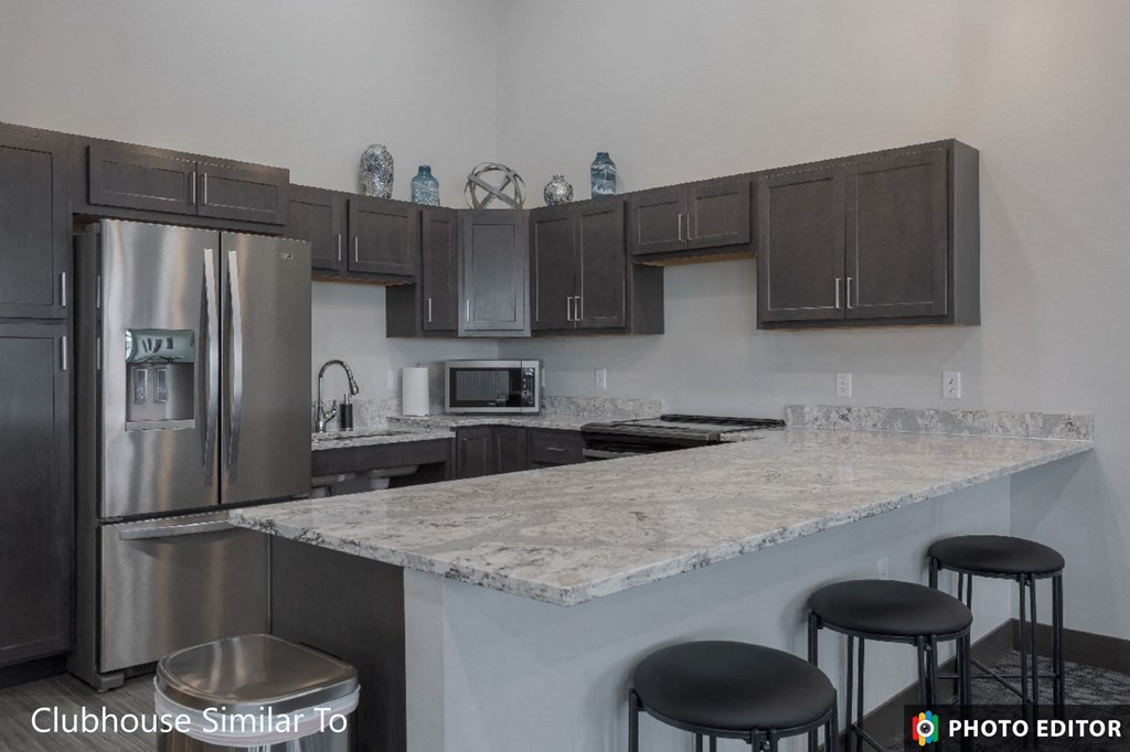 a kitchen with granite counter tops and stainless steel appliances