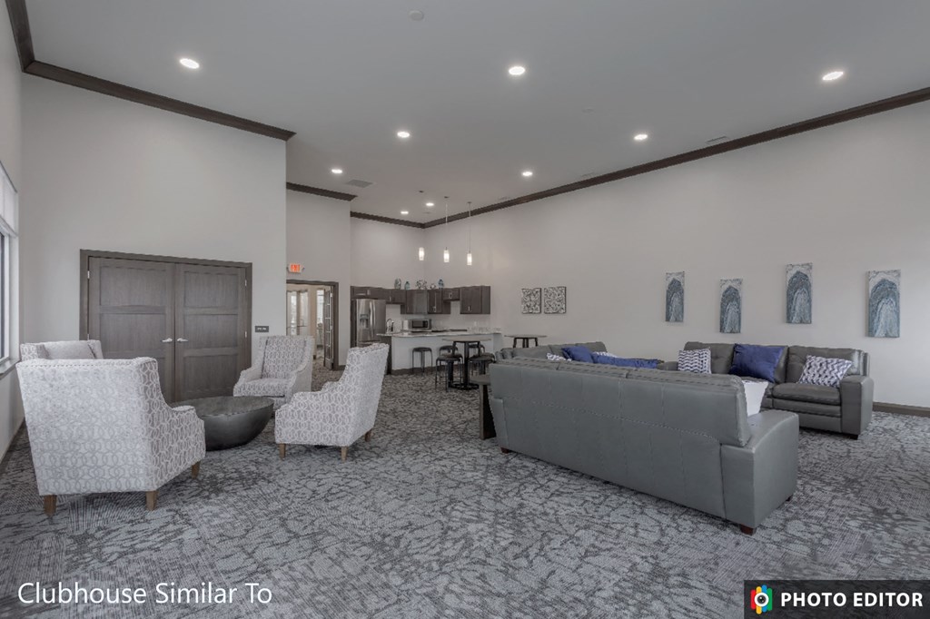 a large living room with couches and chairs and a kitchen