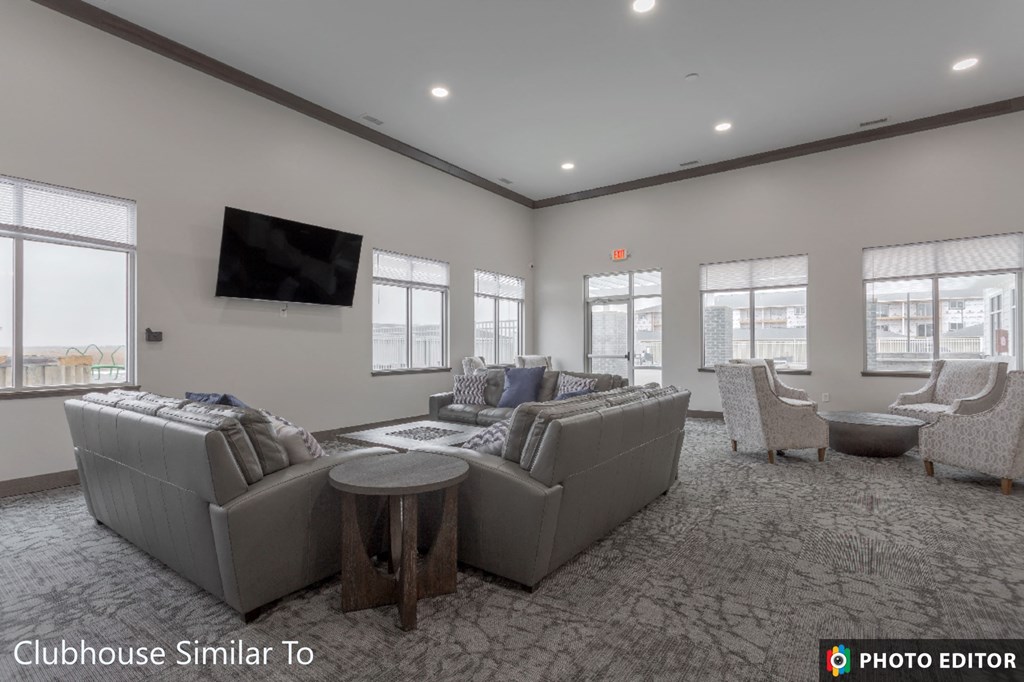 a living room with couches and chairs and a tv