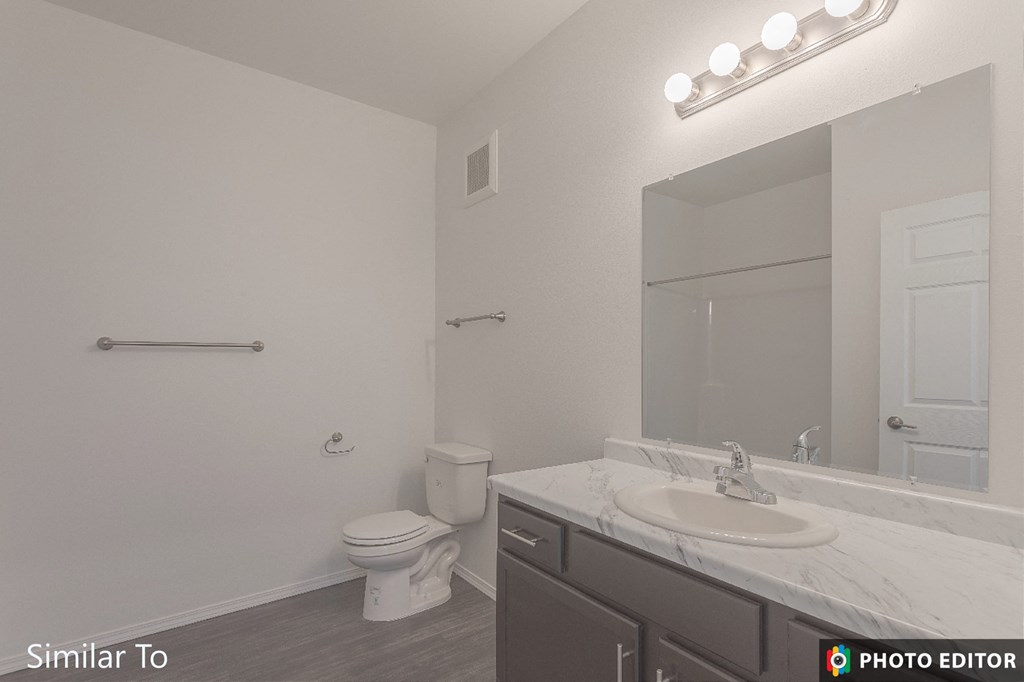 a bathroom with a sink and a toilet and a mirror