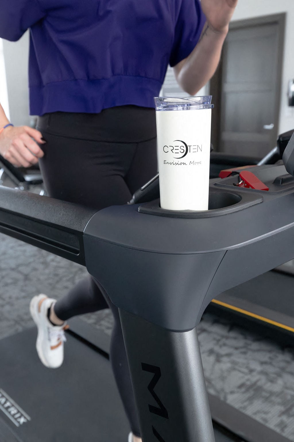 a drink sitting on a treadmill in a gym