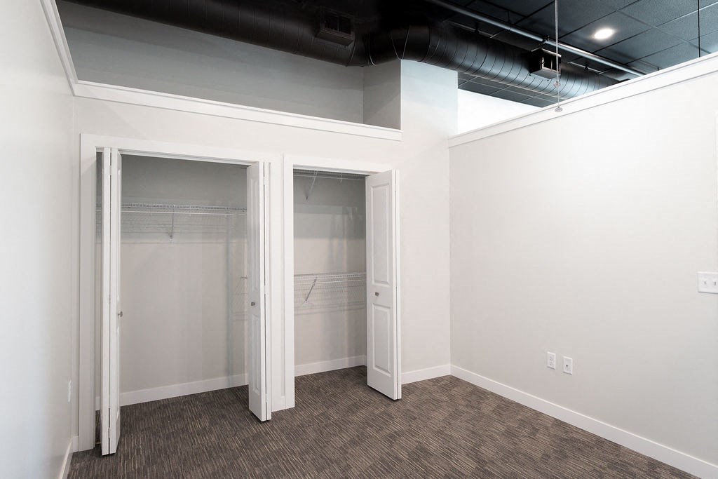 a room with a closet and a mirrored closet door