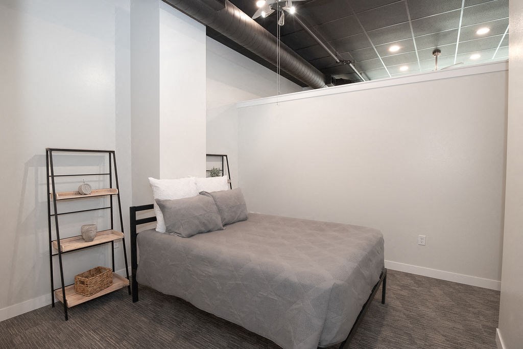 a bedroom with a bed and a shelf