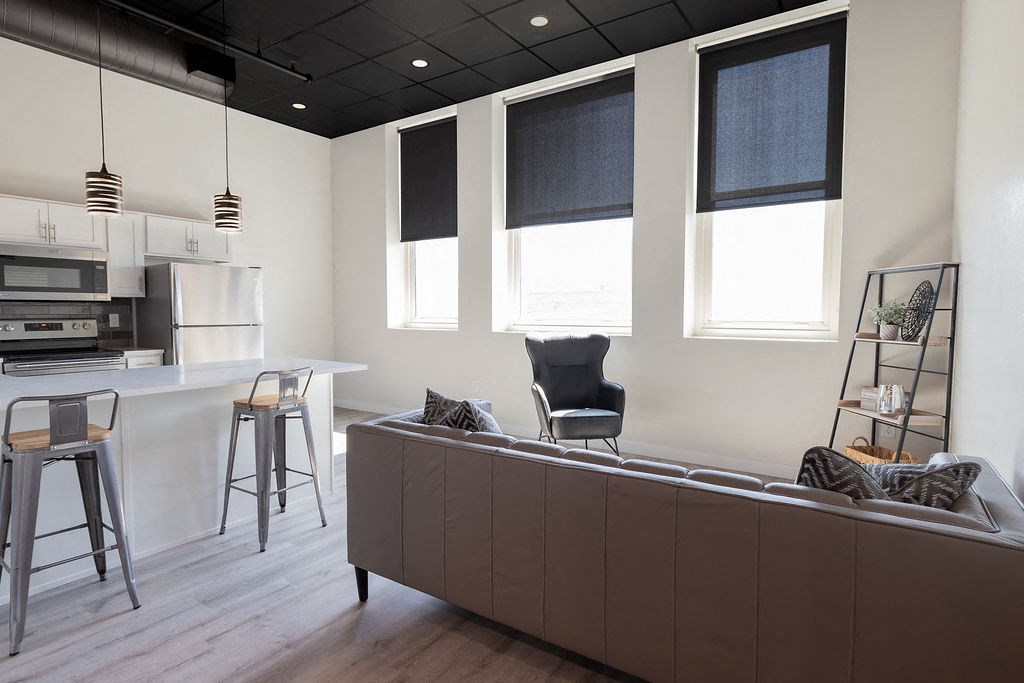 a kitchen and living room with a couch and a table