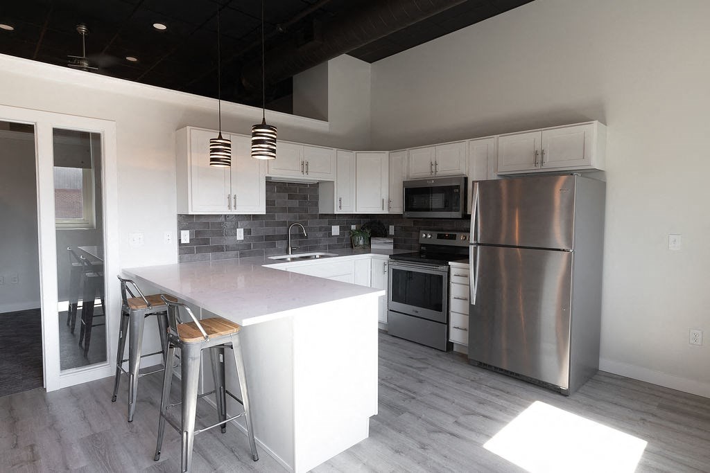 a kitchen with stainless steel appliances and a white counter top