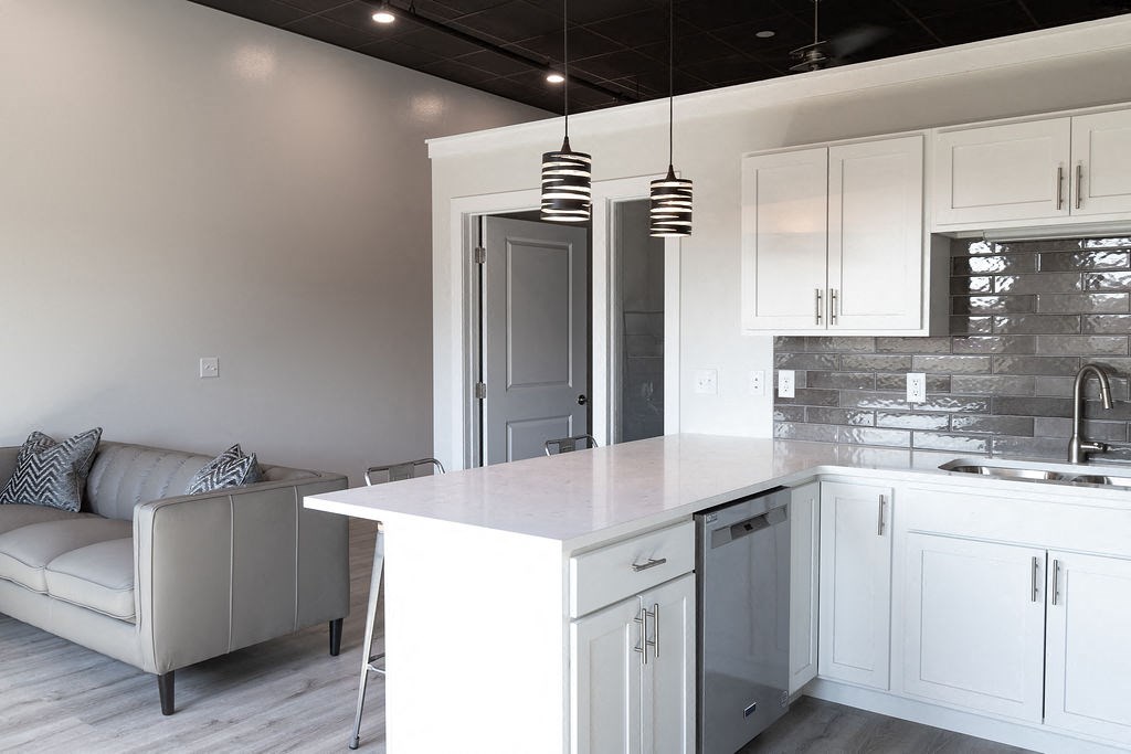 a white kitchen with white cabinets and a white counter top