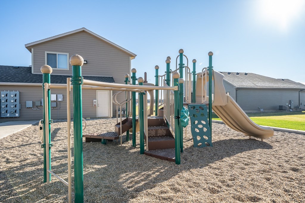 A playground with a slide, swings, and climbing structures.
