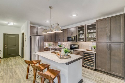 a kitchen with stainless steel appliances and a marble counter top