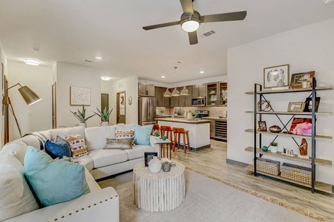 a living room with a couch and a kitchen in the background