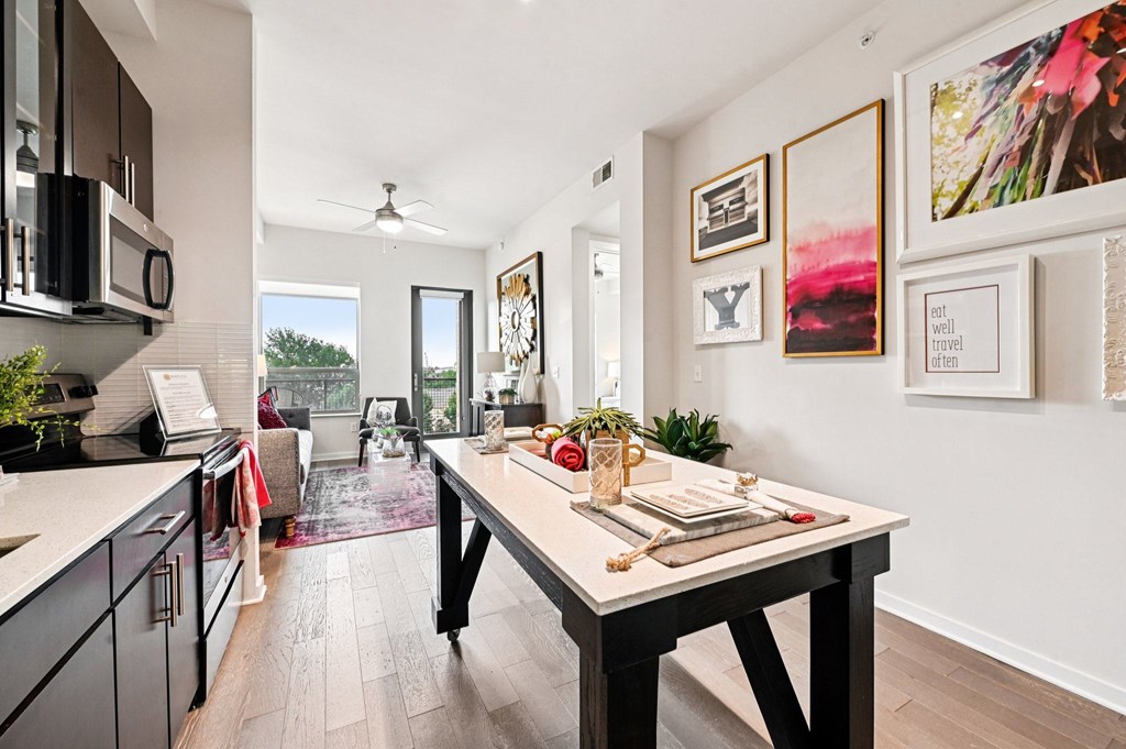 A kitchen with a table and chairs in the middle of the room.