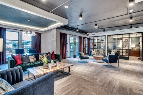 A modern living room with a dark grey sofa and a wooden coffee table.