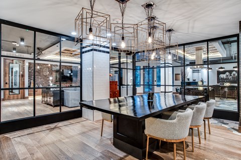 A modern dining room with a long table and chairs.