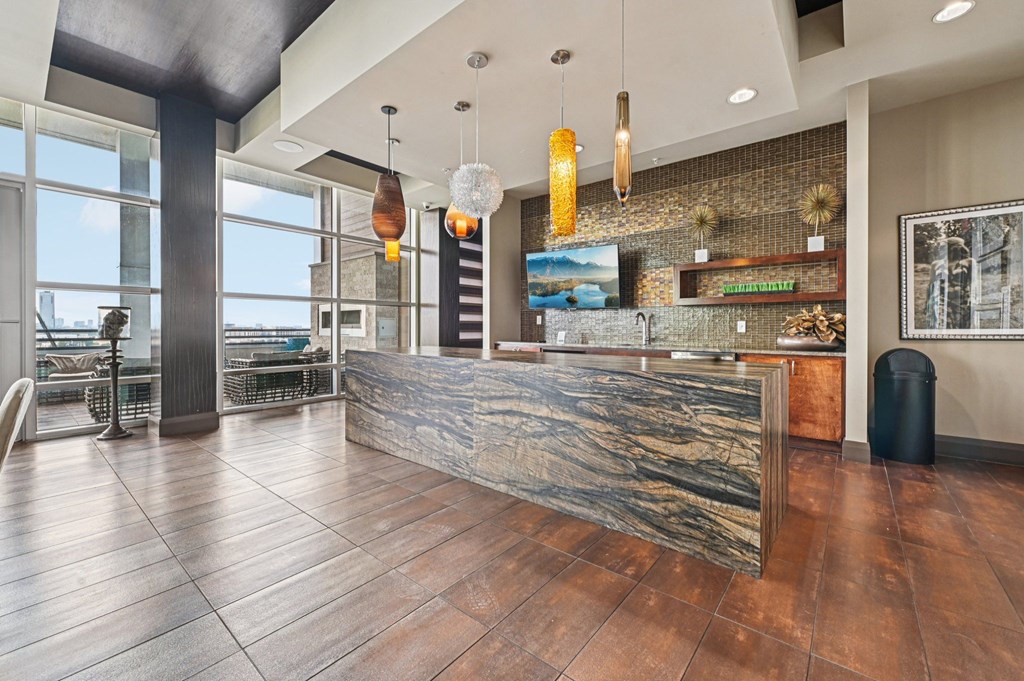 A reception area with a stone counter and a large window.