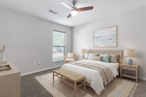 A bedroom with a bed, nightstands, and a ceiling fan.