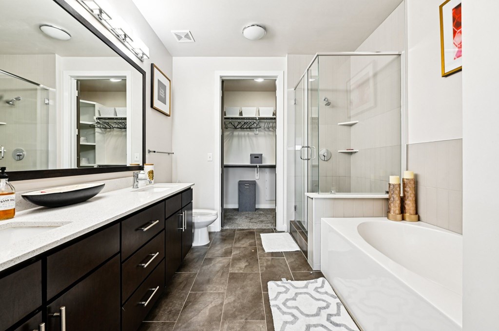 A bathroom with a white tub and a walk in shower.
