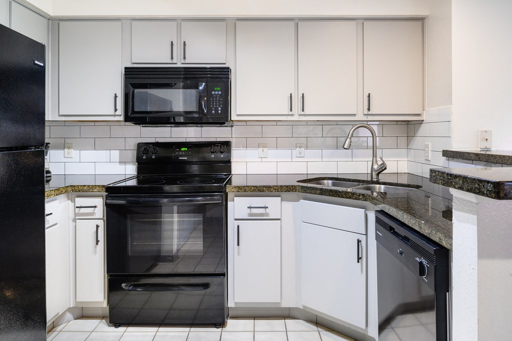 Kitchen with appliances at The Grove at White Oak Apartments, The Barvin Group, Texas