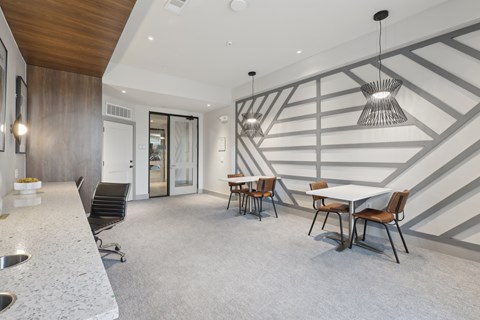 A modern dining room with a white table and chairs.