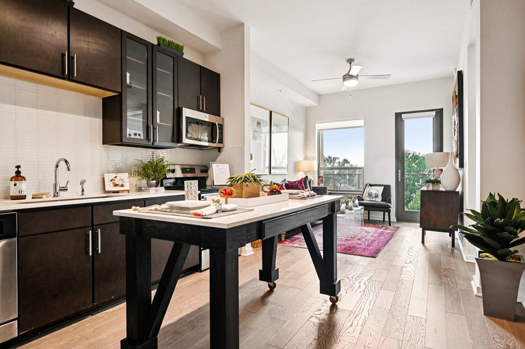 A modern kitchen with a table and chairs in the middle of the room.