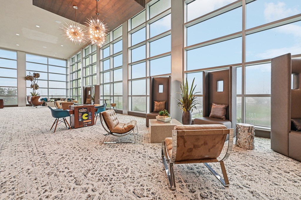 A room with a lot of windows and a carpet on the floor.