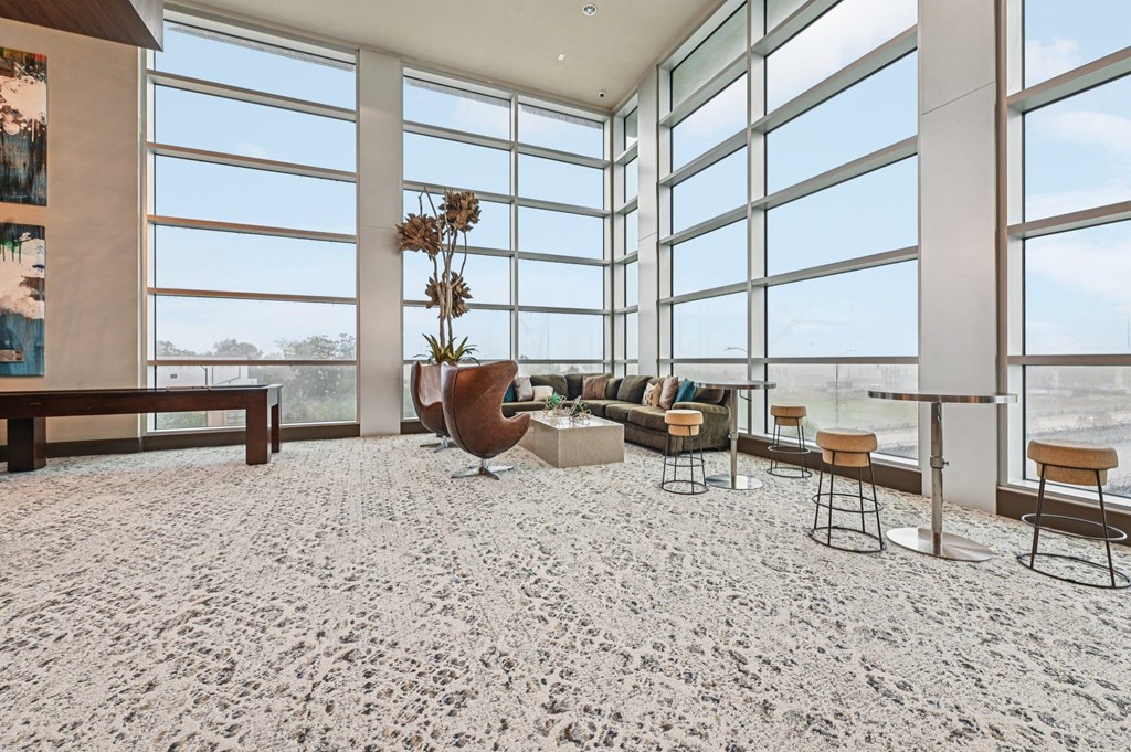 A room with a carpeted floor and a large window.