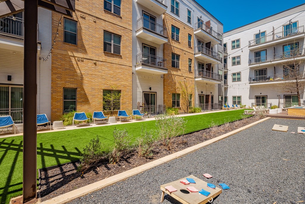 A sunny day at a residential complex with a play area in the foreground.
