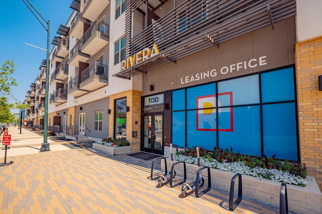 A leasing office for Rivera apartments is shown with a blue sign on the window.