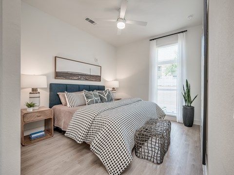 a bedroom with a bed and a ceiling fan