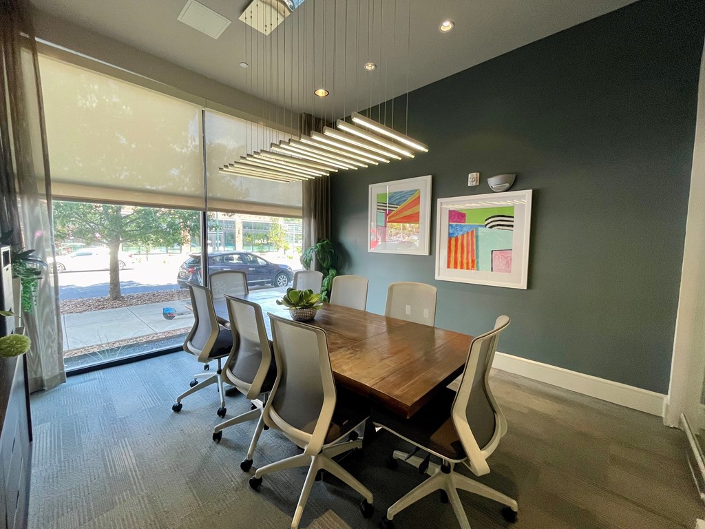 A conference room with a long table and chairs.