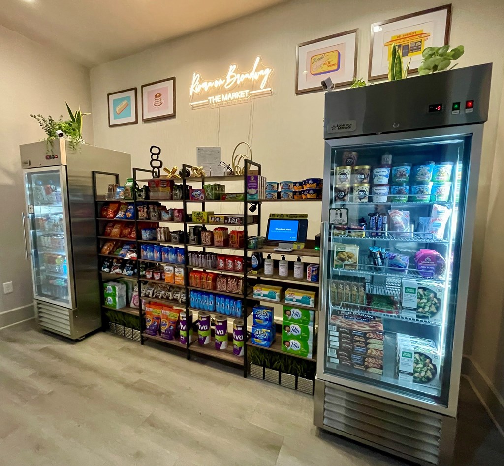 A frozen yogurt shop with two large refrigerators and a display case filled with various frozen treats.