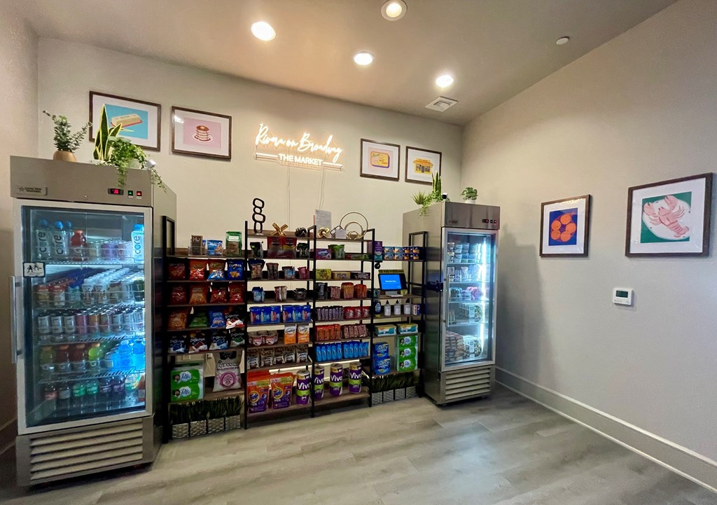 A display of drinks and snacks in a cooler and shelves in a room.