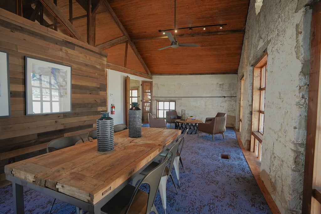a large wooden table and chairs in a room with wooden walls and ceilings
