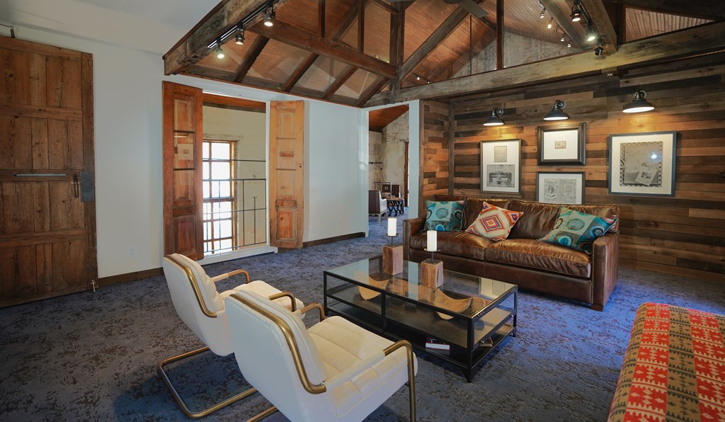 a living room filled with furniture and a glass coffee table