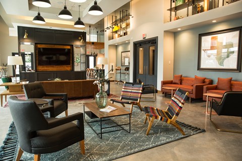 A living room with a black chair and a striped chair.