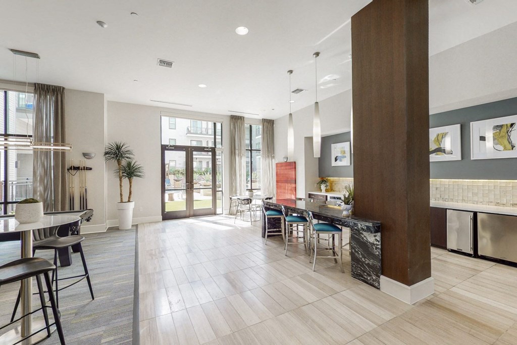 A modern kitchen with a dining table and chairs.