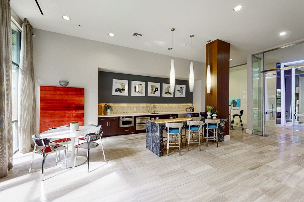 A modern dining room with a white table and chairs.