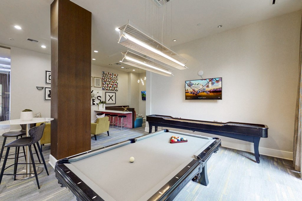 a game room with a pool table and ping pong
