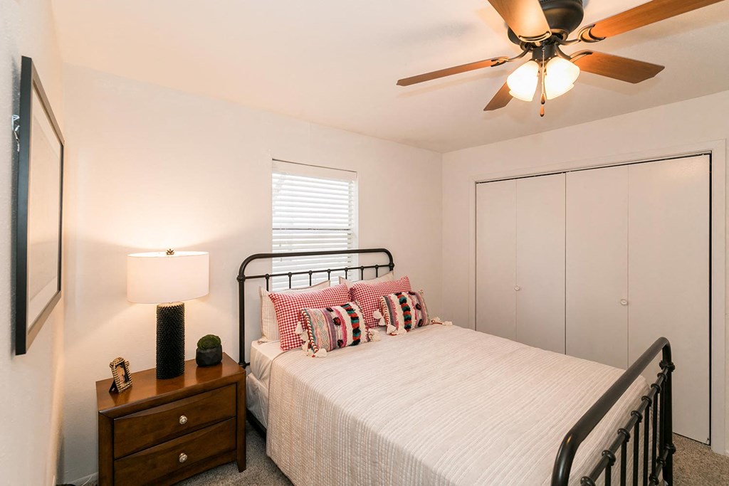 a bedroom with a bed and a ceiling fan