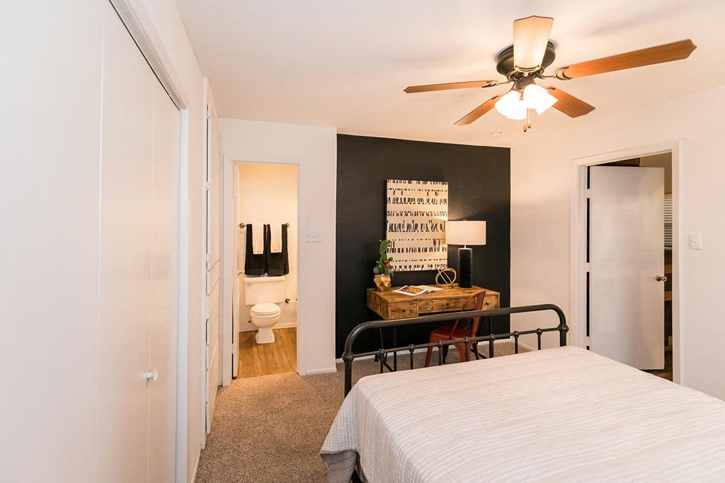 a bedroom with a bed and a ceiling fan